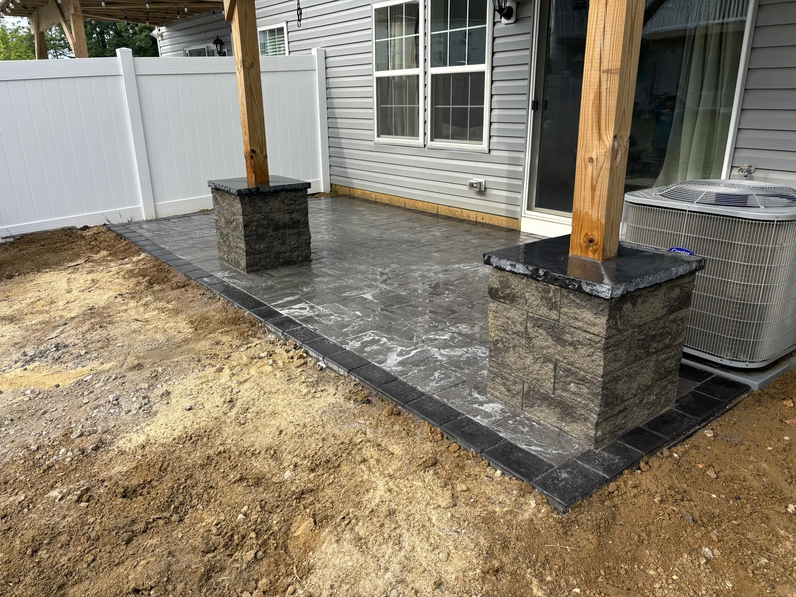 Covered Patio Column Stonework by Down To Earth Landscaping.