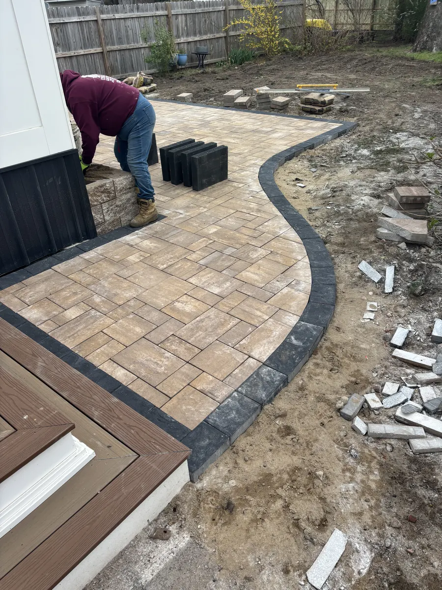 Curved Paver Patio Installation by Down To Earth Landscaping.