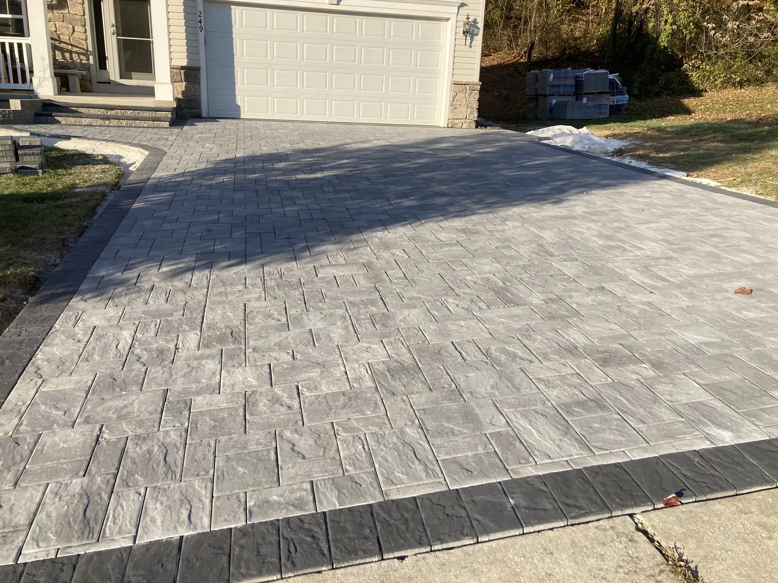 Driveway Paver Border Finished by Down To Earth Landscaping.
