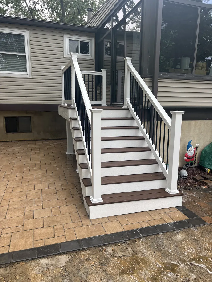 Paver Patio With Deck Steps by Down To Earth Landscaping.