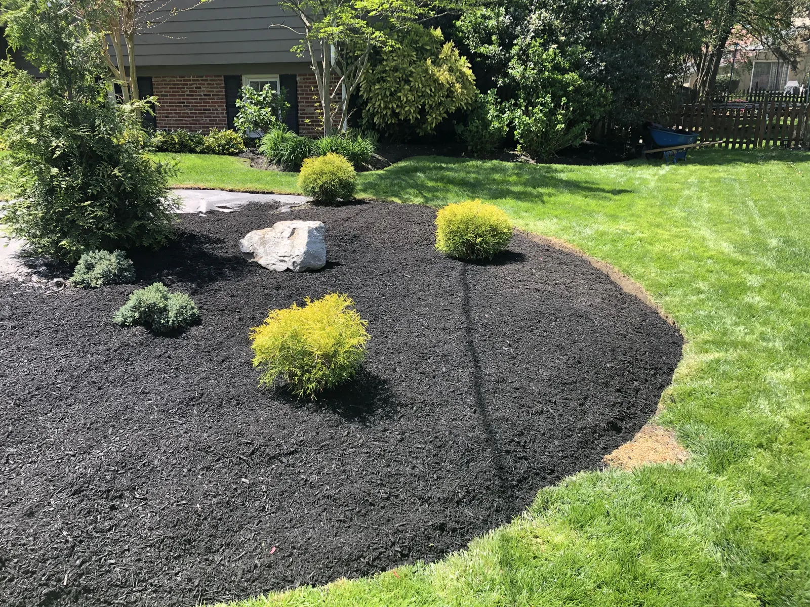 Mulched Garden Bed by Down To Earth Landscaping.