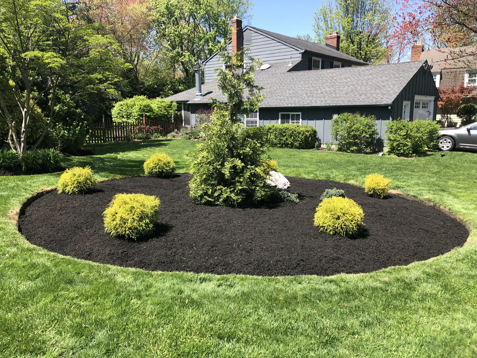 Mulched Garden Bed by Down To Earth Landscaping.