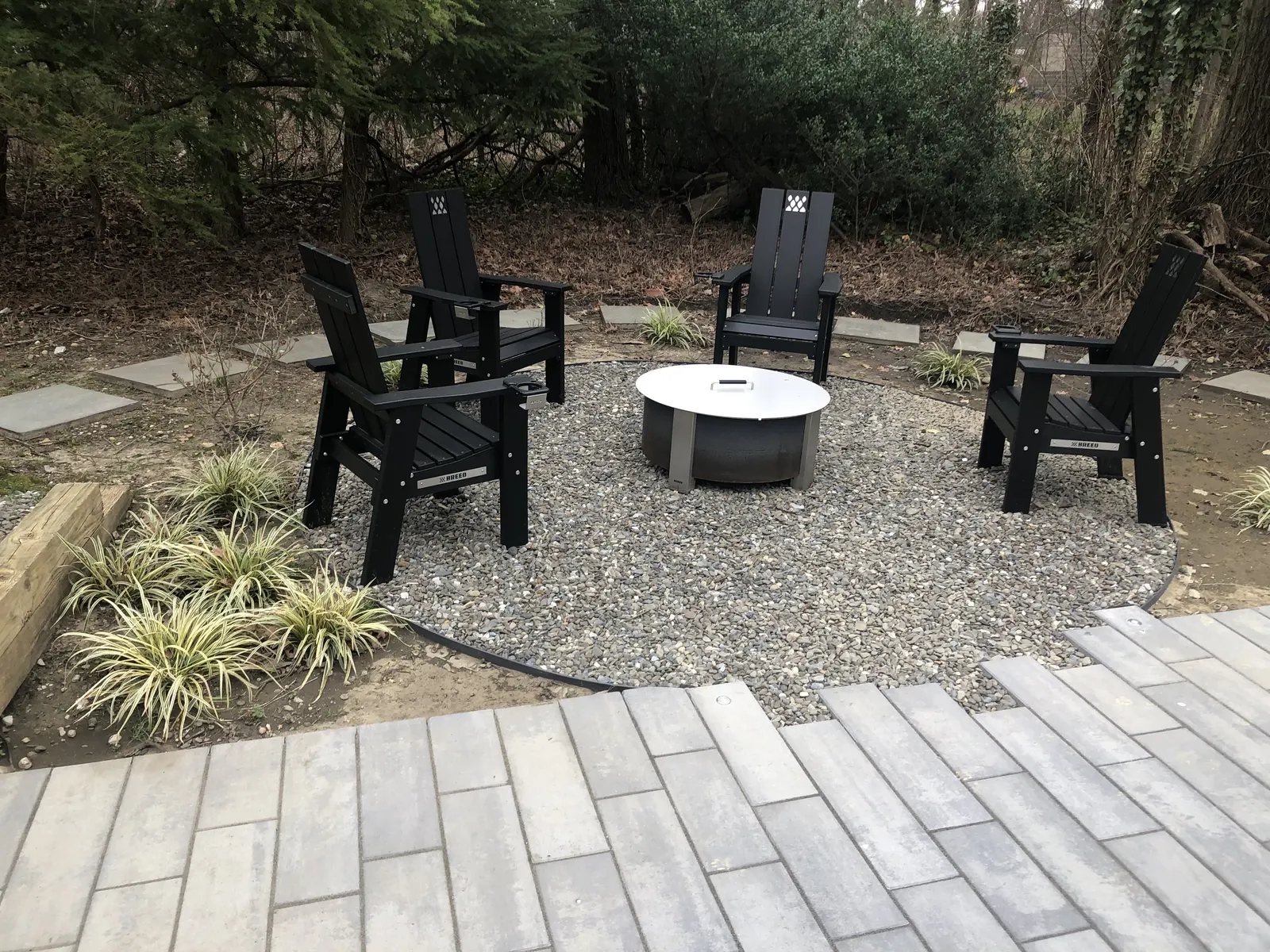 Gravel Fire Pit Area by Down To Earth Landscaping.