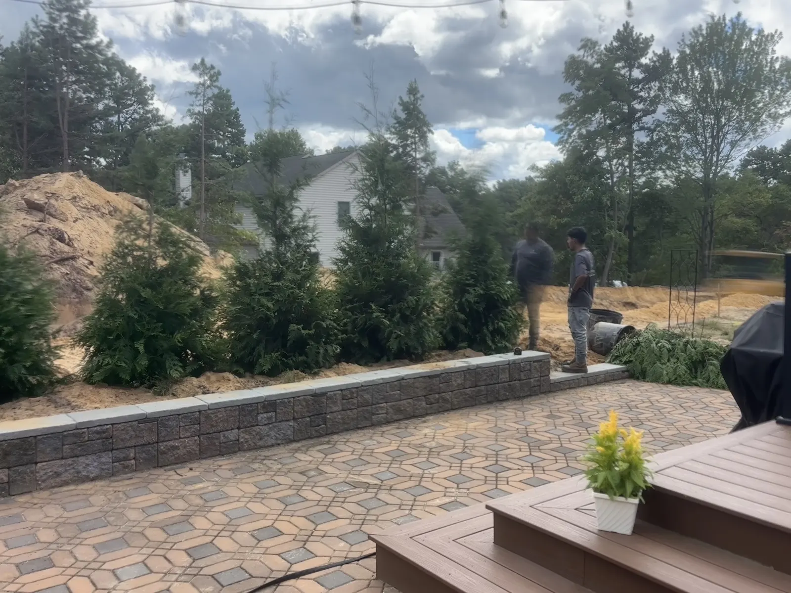 Retaining Wall Outdoor Room by Down To Earth Landscaping.
