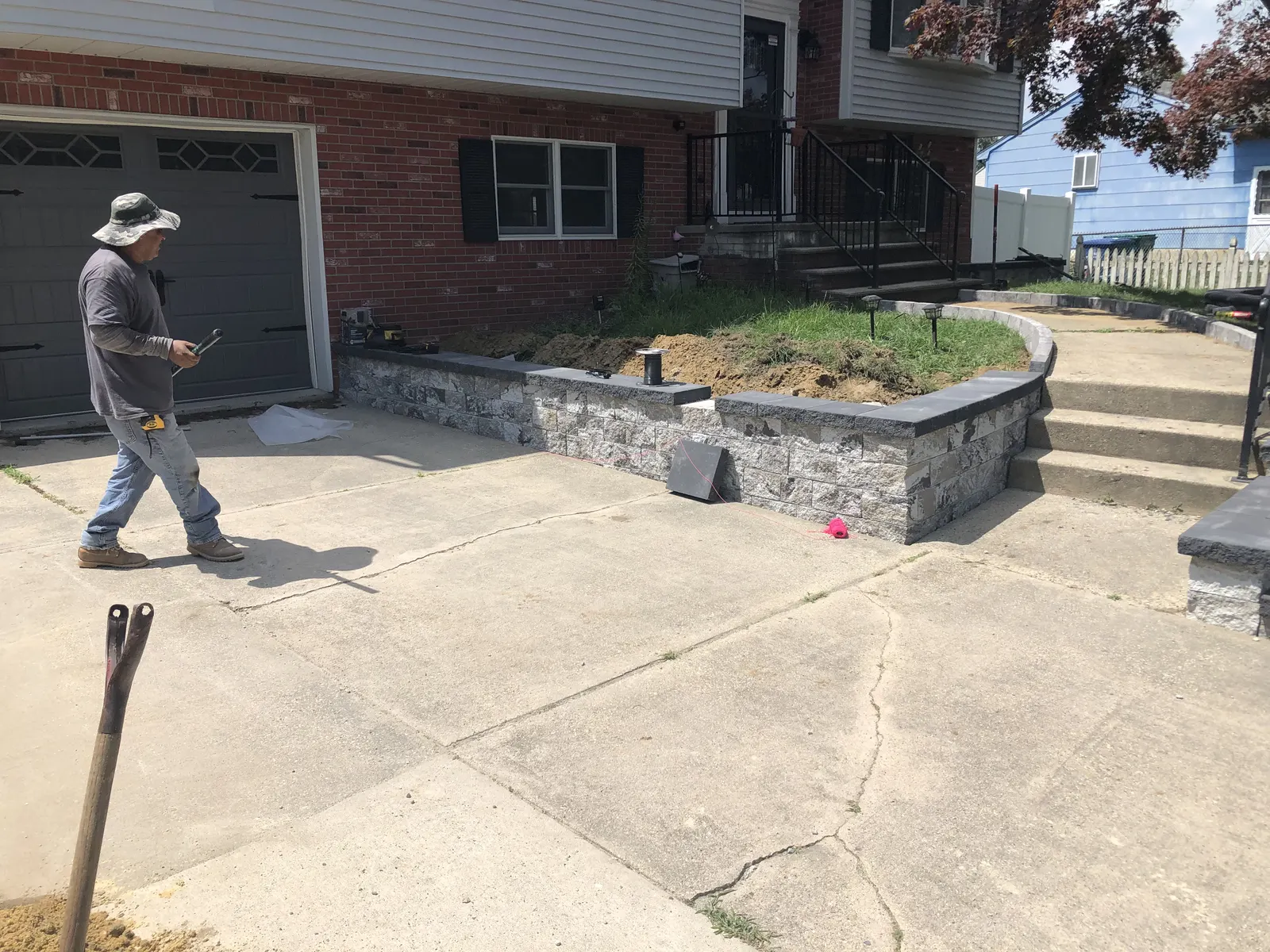 Circular Retaining Wall Before by Down To Earth Landscaping.