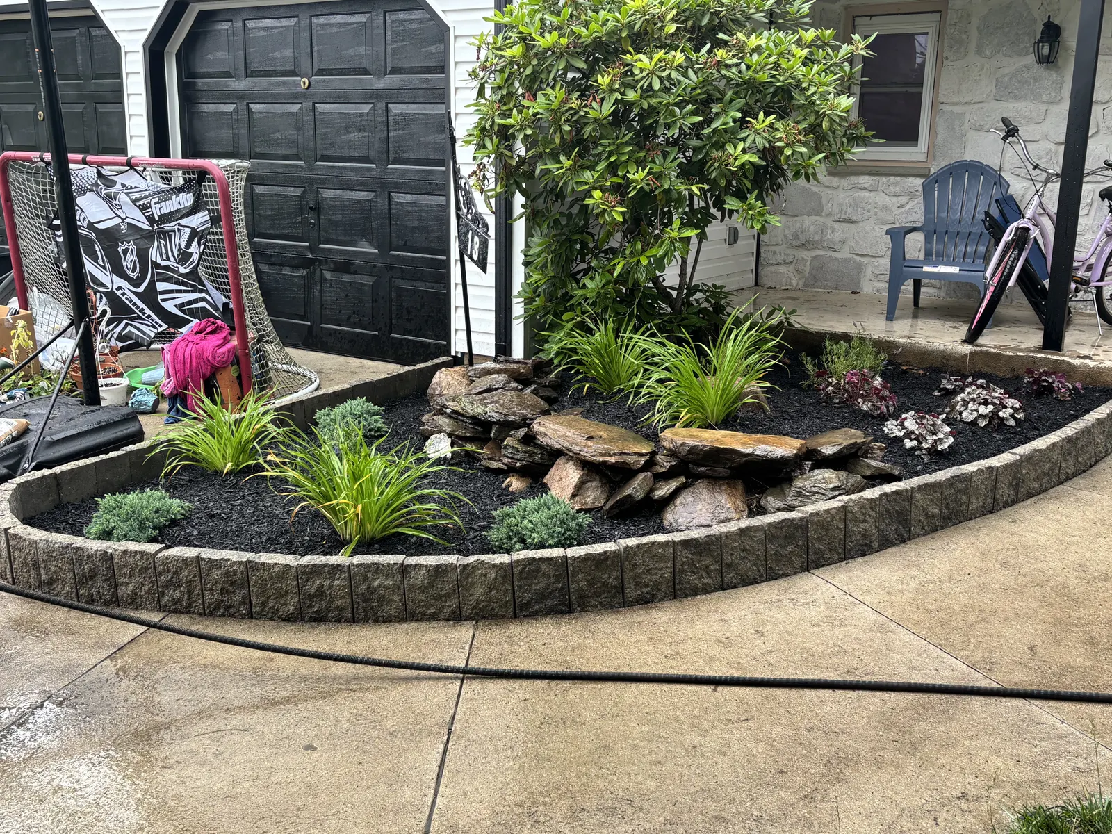 Natural Stone Border Front Bed by Down To Earth Landscaping.
