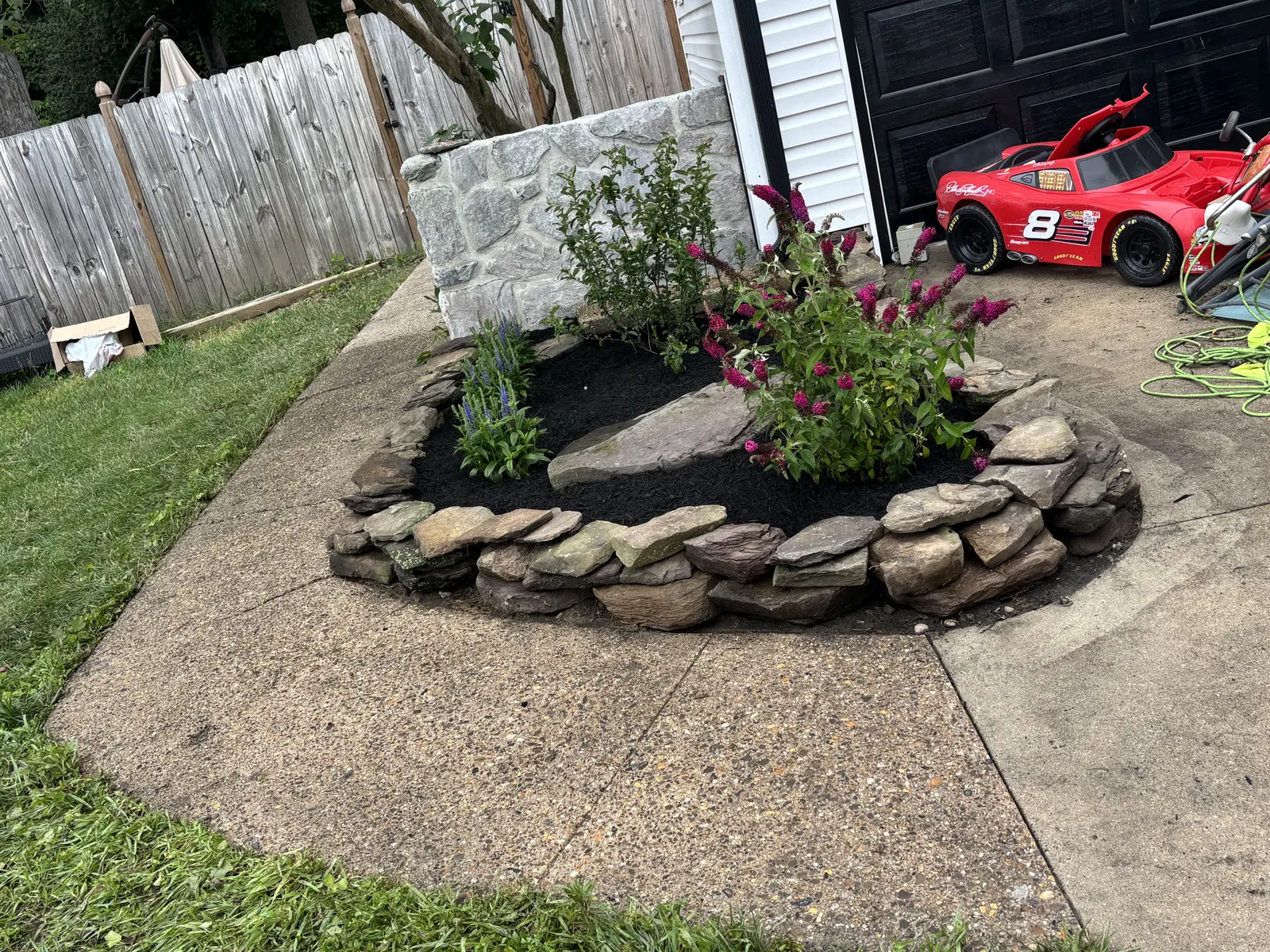 Natural Stone Flower Bed by Down To Earth Landscaping.